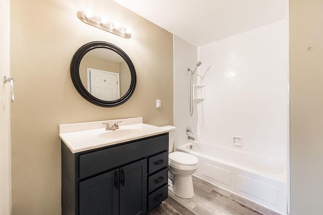 bathroom with shower / bathing tub combination, vanity, toilet, and wood finished floors