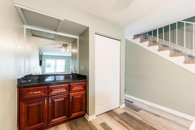 bathroom featuring vanity, baseboards, and wood finished floors