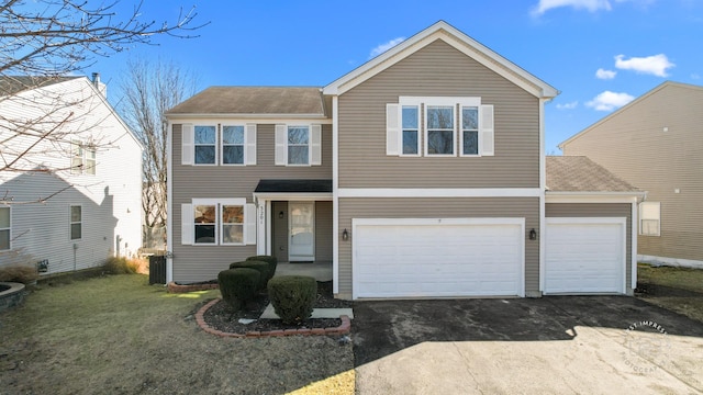 traditional home featuring driveway, a front yard, and central air condition unit