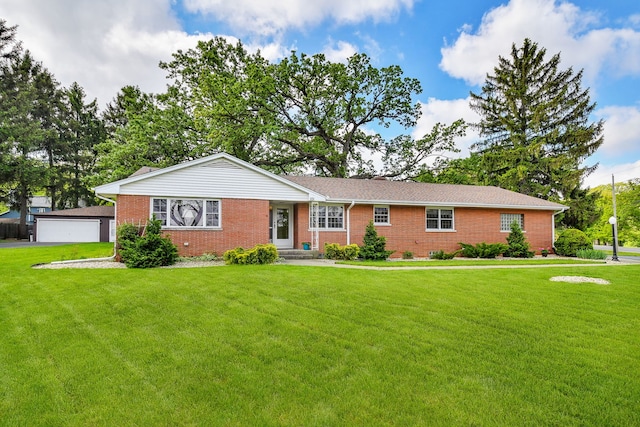 ranch-style home with brick siding, a front yard, and a garage