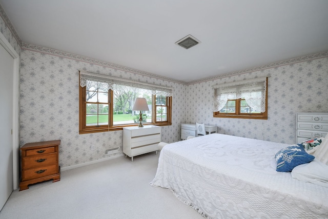 bedroom featuring carpet floors and wallpapered walls