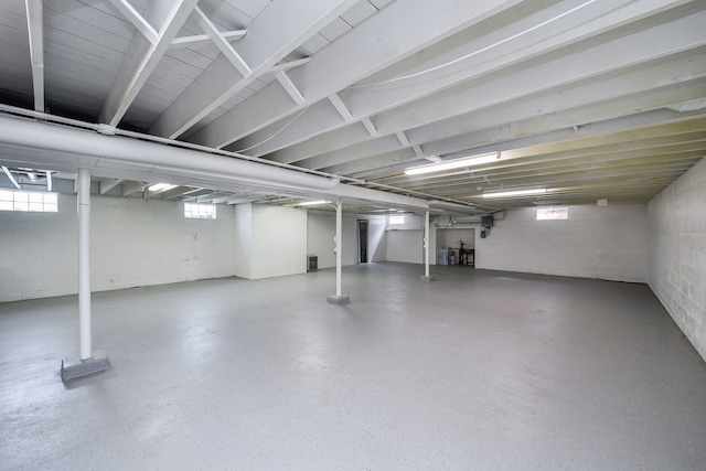 basement with concrete block wall and plenty of natural light
