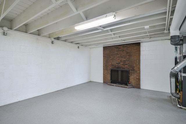 below grade area with a brick fireplace