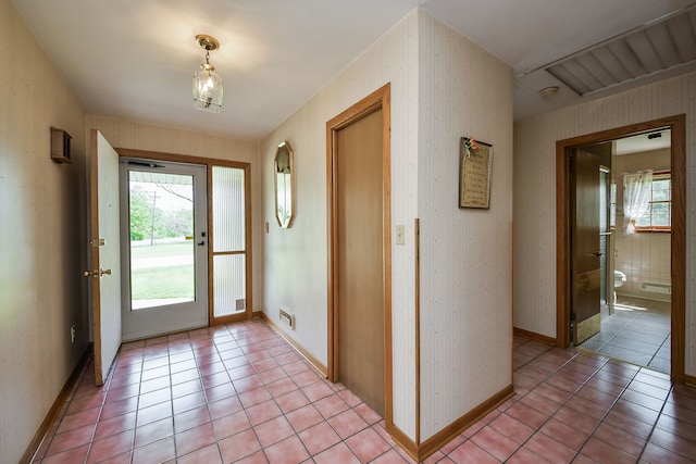 entrance foyer featuring light tile patterned floors and baseboards
