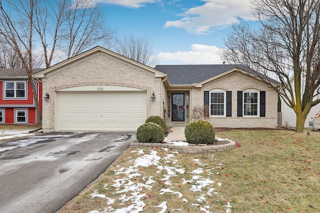 single story home featuring a garage, aphalt driveway, a shingled roof, and brick siding