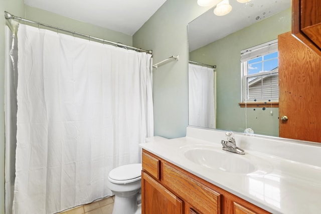 full bathroom with toilet, tile patterned flooring, and vanity