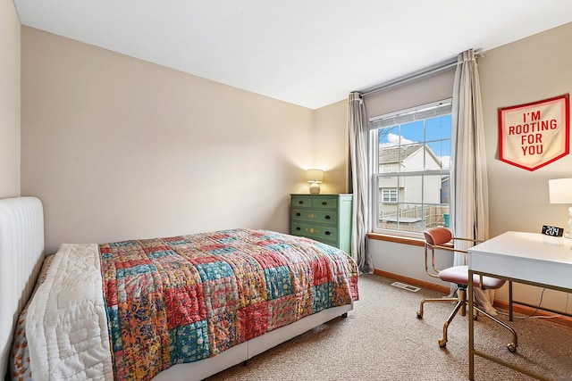 bedroom with carpet floors, baseboards, and visible vents