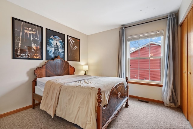 bedroom with carpet, visible vents, and baseboards