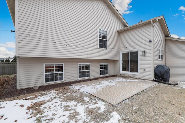 back of property with a patio area and fence