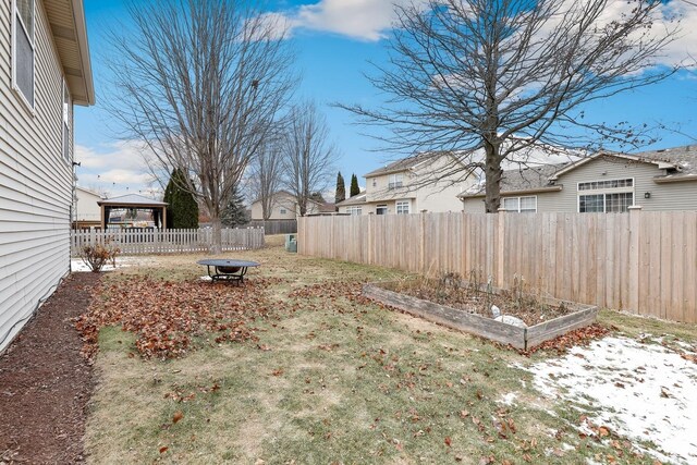 view of yard featuring fence private yard, a garden, and a gazebo