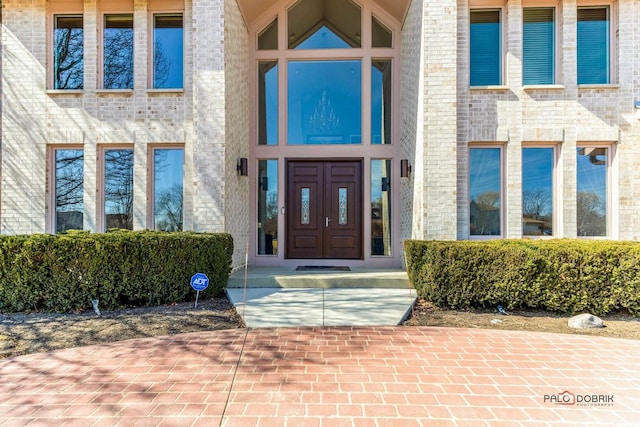 view of exterior entry with brick siding