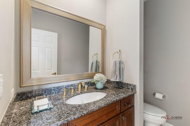 bathroom with toilet and vanity