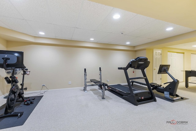 exercise area featuring recessed lighting, a paneled ceiling, baseboards, and carpet floors