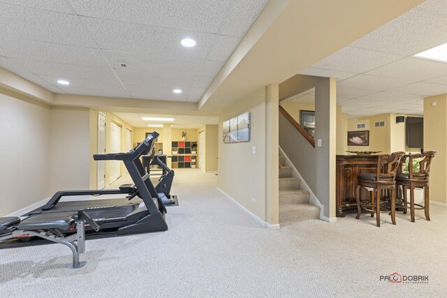 workout area featuring a bar, visible vents, carpet, and baseboards