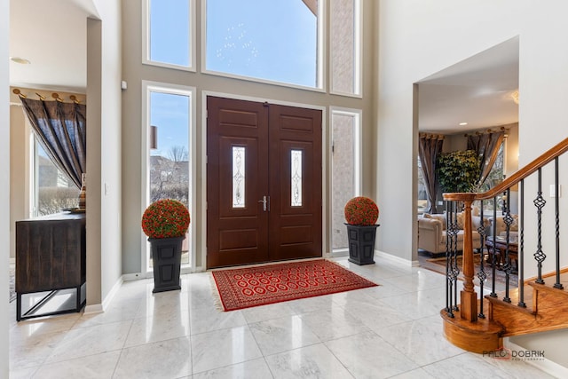 entrance foyer featuring a high ceiling and a wealth of natural light