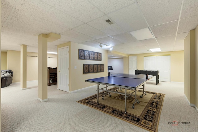 rec room with a paneled ceiling, baseboards, and carpet floors