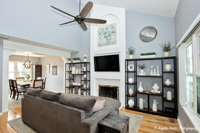 living room with a healthy amount of sunlight, a fireplace, and light wood-style floors