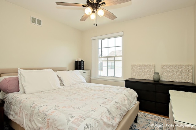 bedroom with ceiling fan and visible vents