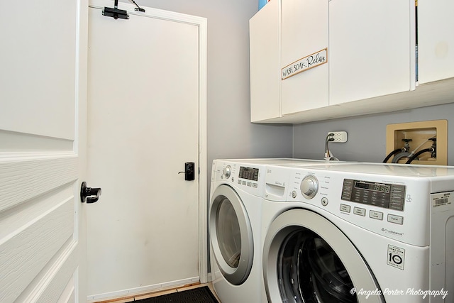 laundry area featuring cabinet space, washer and clothes dryer, and baseboards