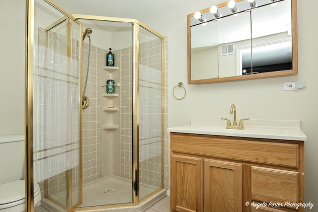 bathroom featuring visible vents, vanity, a shower stall, and toilet