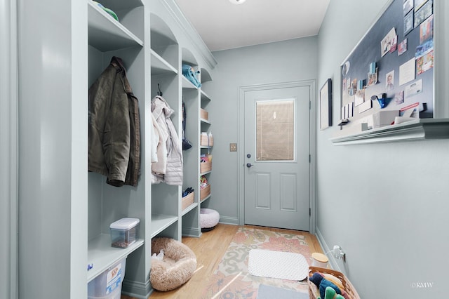 mudroom featuring baseboards and wood finished floors