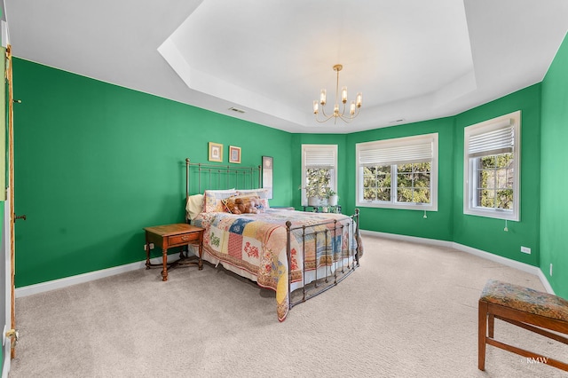 bedroom with baseboards, a raised ceiling, carpet floors, and a chandelier