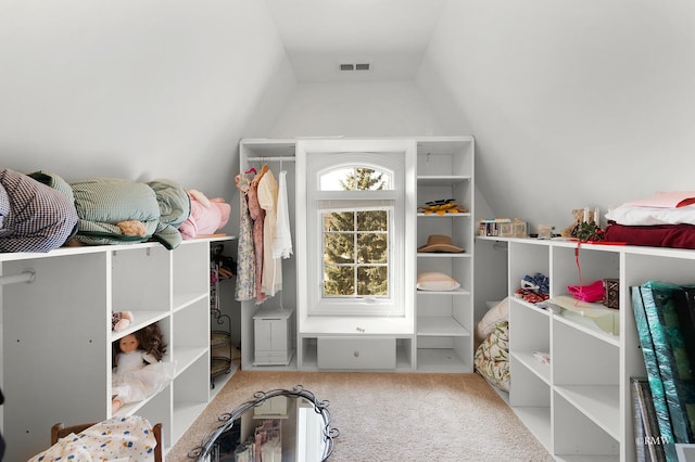 spacious closet featuring visible vents, carpet, and vaulted ceiling