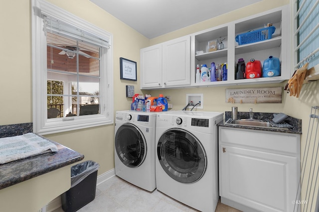 clothes washing area with a ceiling fan, a sink, cabinet space, baseboards, and washing machine and clothes dryer