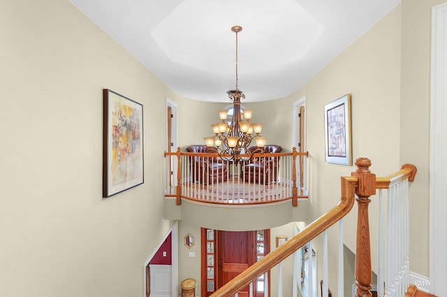 stairs featuring a chandelier