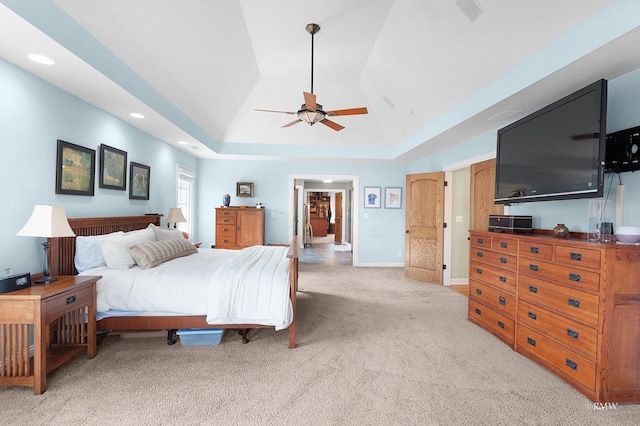 bedroom featuring light carpet, lofted ceiling, a ceiling fan, recessed lighting, and a raised ceiling