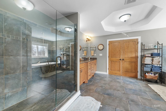 bathroom with visible vents, baseboards, a stall shower, vanity, and a raised ceiling