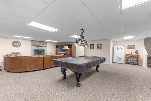 recreation room with a fireplace, a paneled ceiling, baseboards, and carpet floors