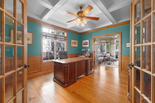 office featuring light wood-type flooring, coffered ceiling, french doors, wainscoting, and ceiling fan