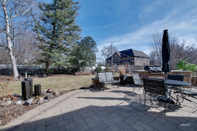 view of patio featuring outdoor dining area and fence