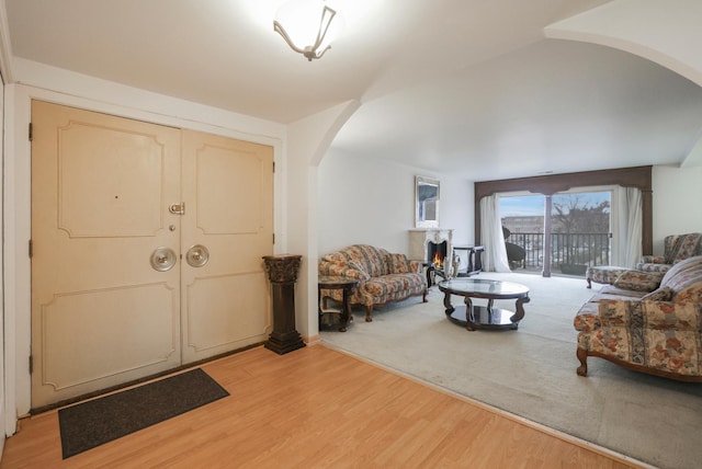 entrance foyer with arched walkways and light wood-style flooring