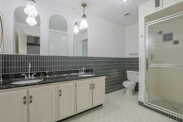 full bathroom with tile patterned flooring, visible vents, a sink, and a shower stall