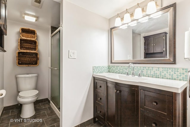 bathroom featuring visible vents, backsplash, a stall shower, and toilet