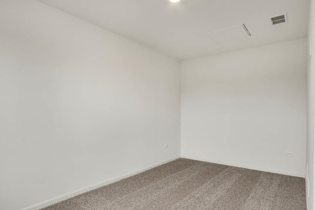 unfurnished room with carpet flooring, visible vents, and baseboards