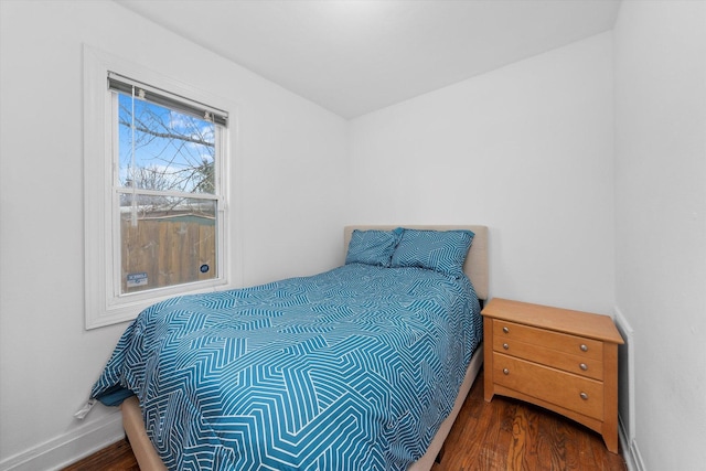 bedroom with baseboards and wood finished floors