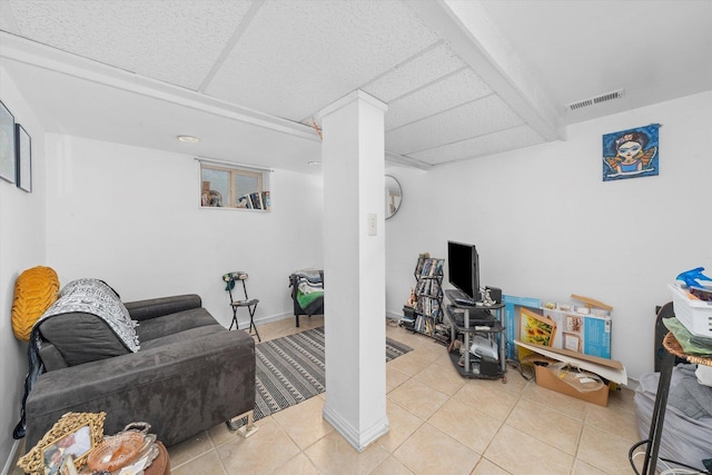 tiled living room featuring baseboards and visible vents