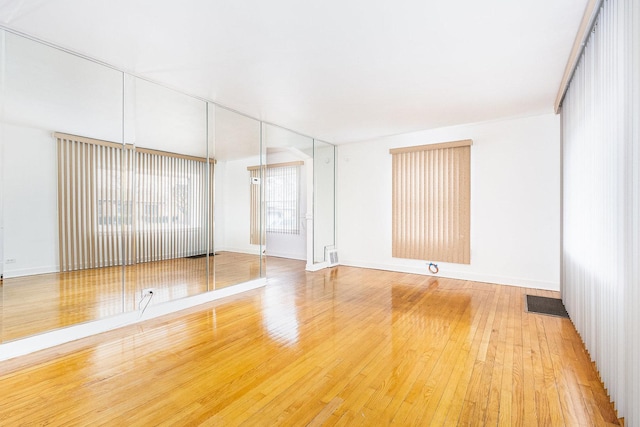 spare room featuring light wood-style flooring and baseboards