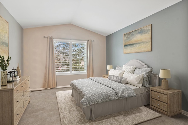 bedroom with lofted ceiling, light colored carpet, visible vents, and baseboards