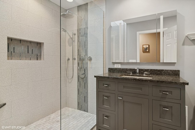 full bathroom featuring a walk in shower and vanity