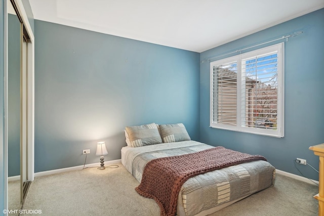 bedroom with carpet flooring and baseboards