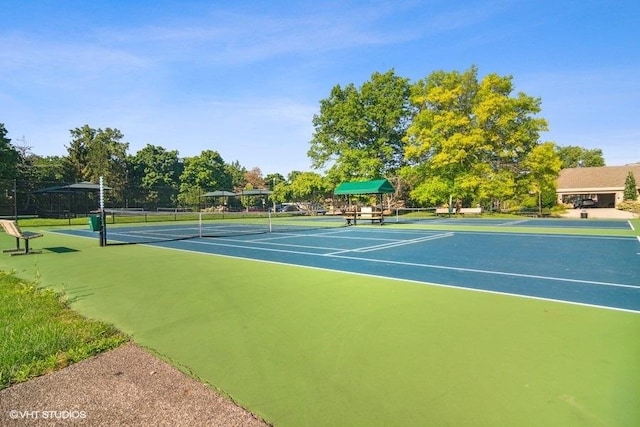 view of tennis court featuring fence