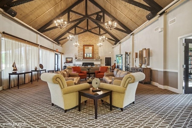 carpeted living area featuring a chandelier, wooden ceiling, visible vents, and beamed ceiling