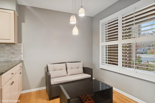 living area with light wood finished floors and baseboards