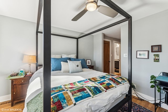 bedroom with wood finished floors, baseboards, and ceiling fan