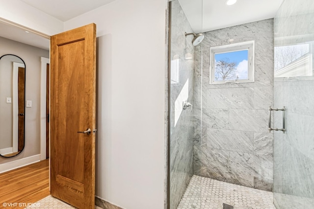 bathroom with baseboards and a stall shower