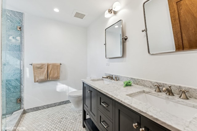 bathroom featuring tile patterned floors, a shower stall, toilet, and a sink